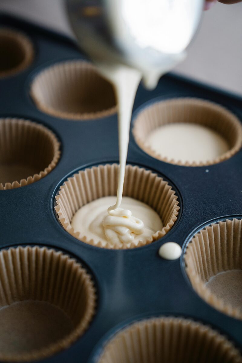 Pouring batter into paper-lined cupcake tin