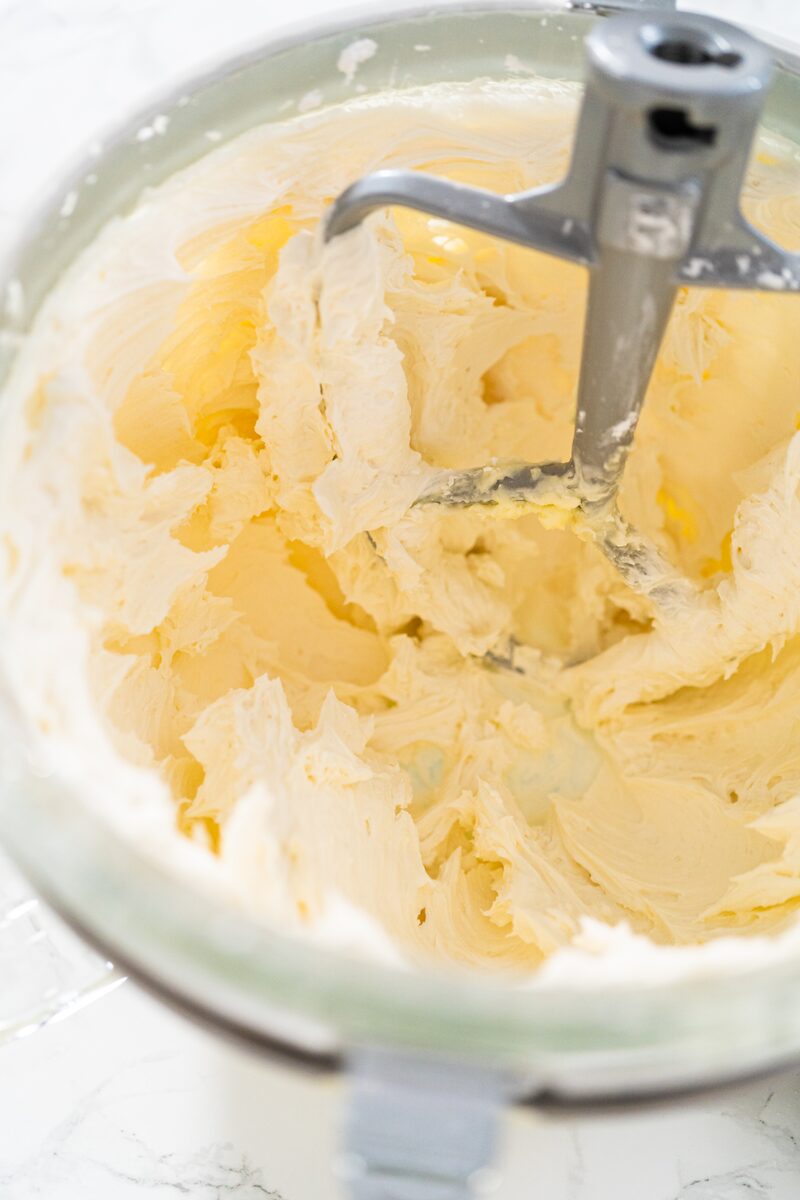 Vegan butter and sugar creamed to a pale, fluffy mixture in a stand mixer bowl with the paddle attachment