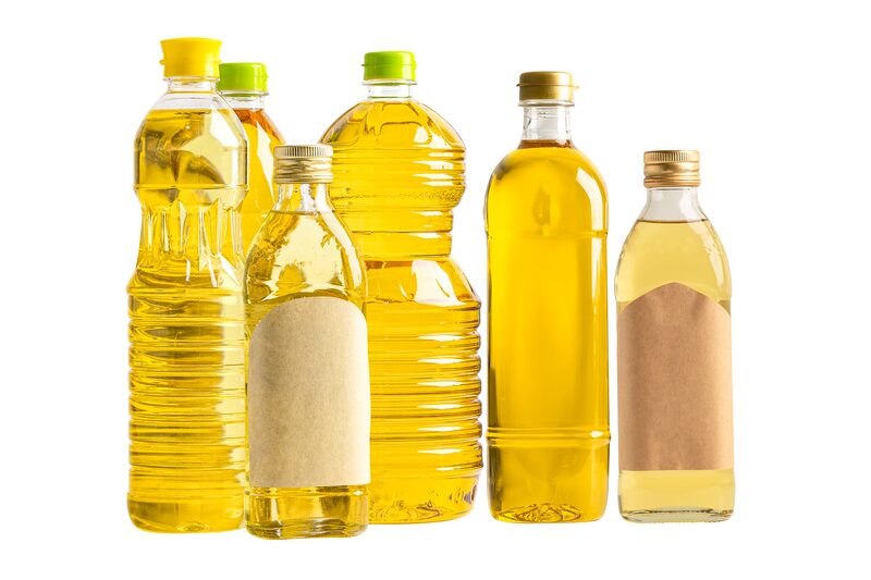 Bottles of cooking oil in different shapes and sizes on a white background