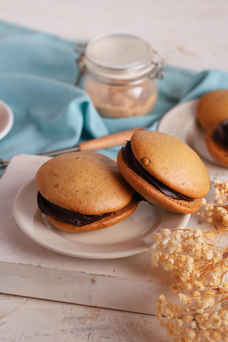 Two gluten-free whoopie pies filled with chocolate ganache