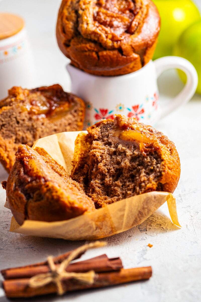 Gluten-free apple cinnamon muffin split in half, showing a soft, even crumb