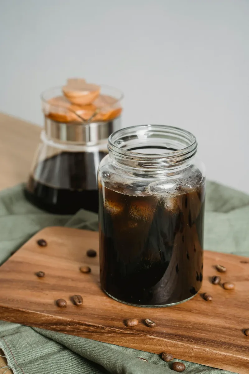 Finished cold brew concentrate in a glass jar on a wood cutting board