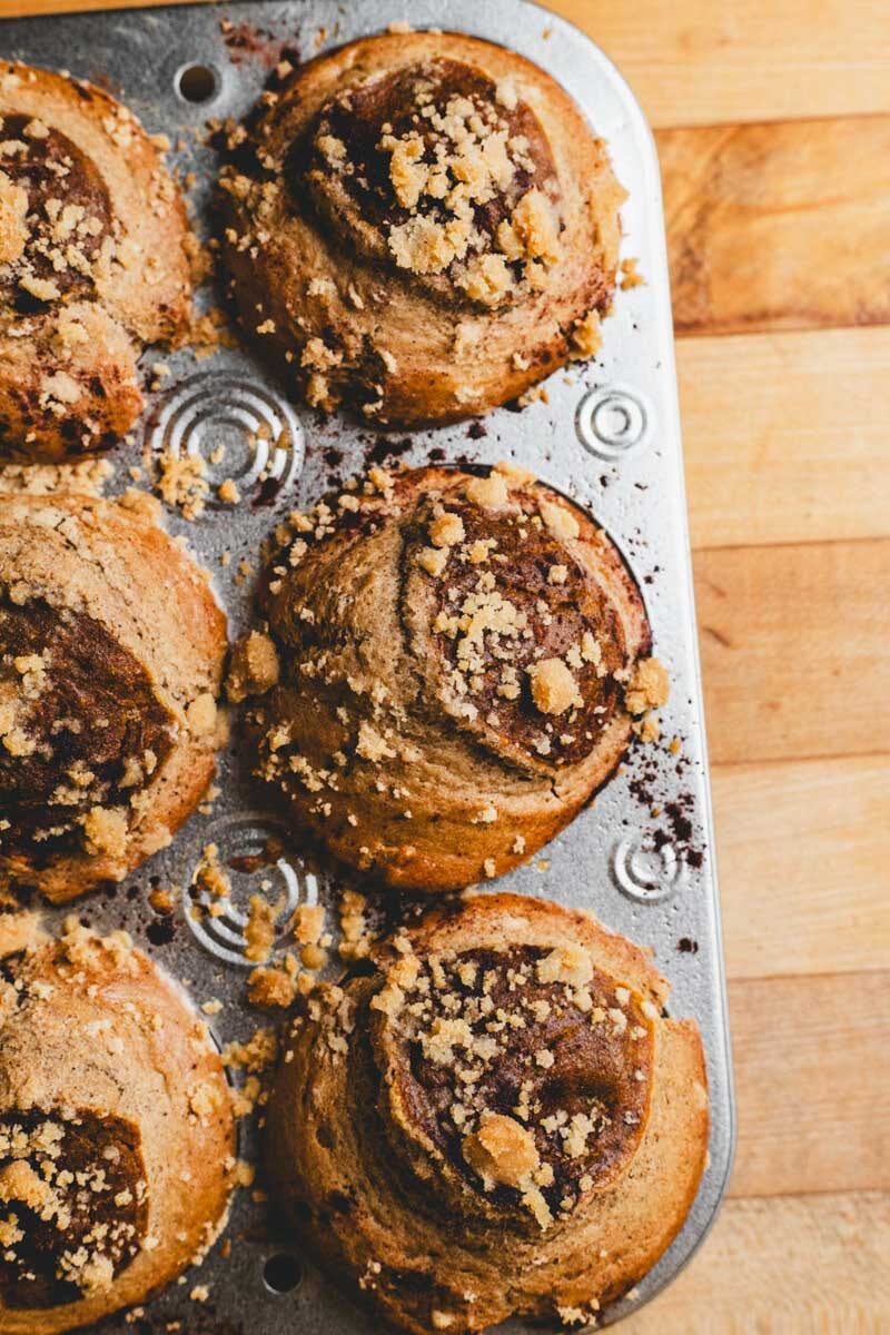 Close-up of pumpkin pie muffins with crumb topping in a muffin tin