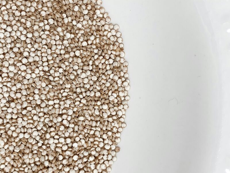 Raw quinoa piled on a white plate