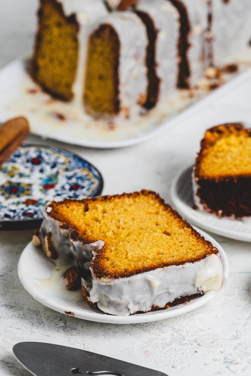 Layer cake topped with swirls of smooth whipped frosting and sliced almonds
