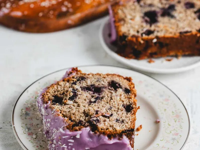 Folding frozen blueberries into muffin batter with a silicone spatula