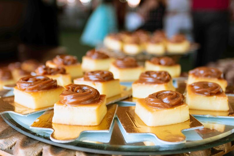 Bite-size cake squares topped with swirls of caramelized dulce de leche on a platter